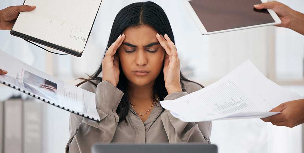 Stress, headache and burnout of business woman, overworked or overwhelmed by deadline or employees on office computer. Mental health, multitasking and frustrated female depressed in toxic workplace.